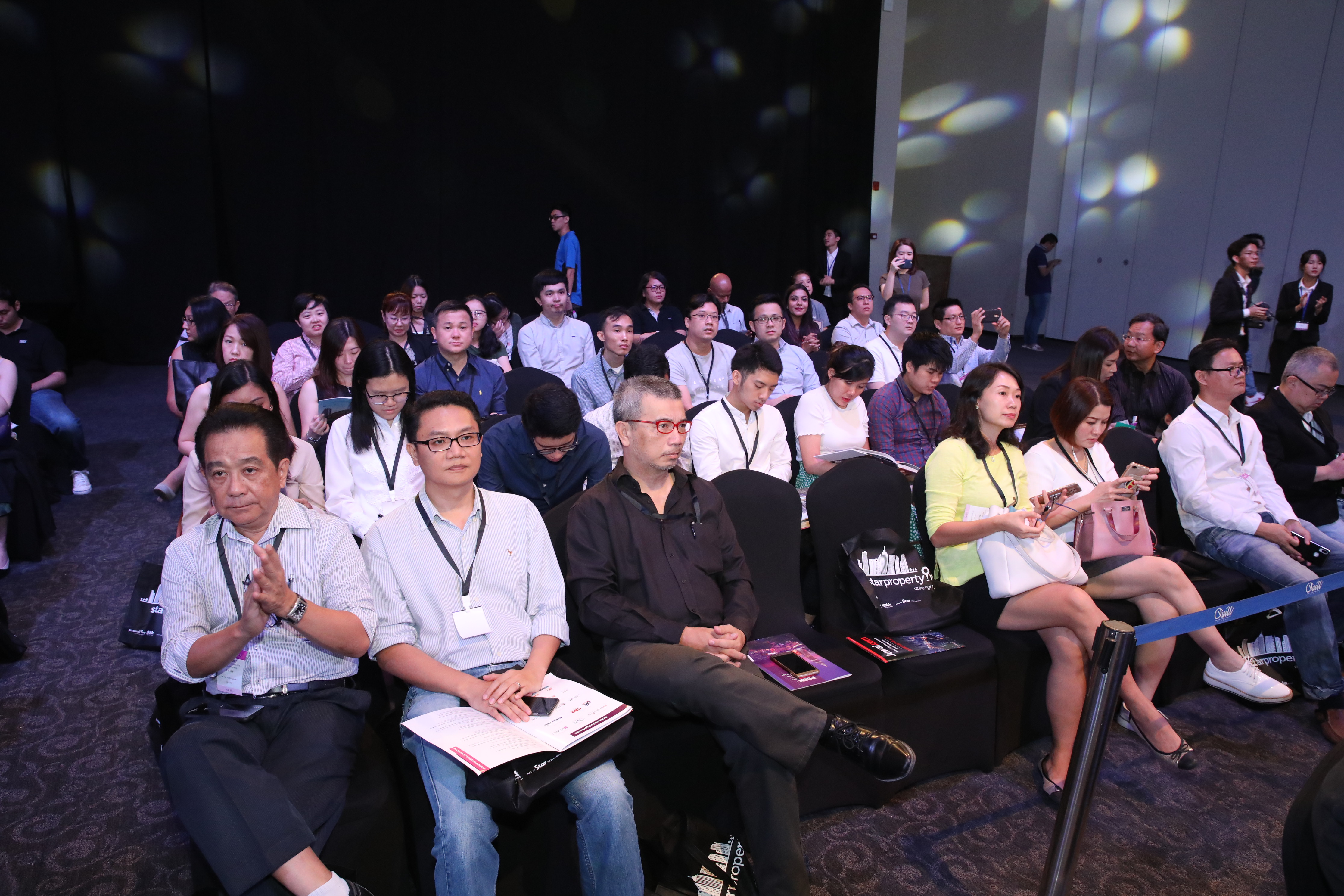Audience members seated and engaged during a presentation.